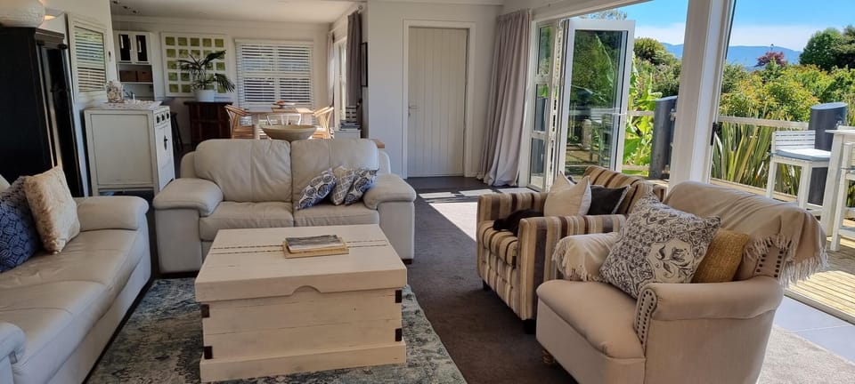 Relaxed coastal vibe in the lounge flows through to open plan dining and kitchen