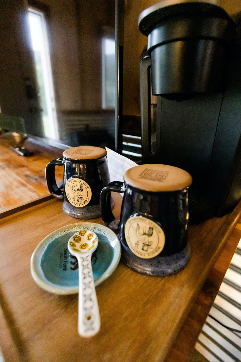 Complimentary coffee setup with handcrafted mugs inside cozy mountain cabin