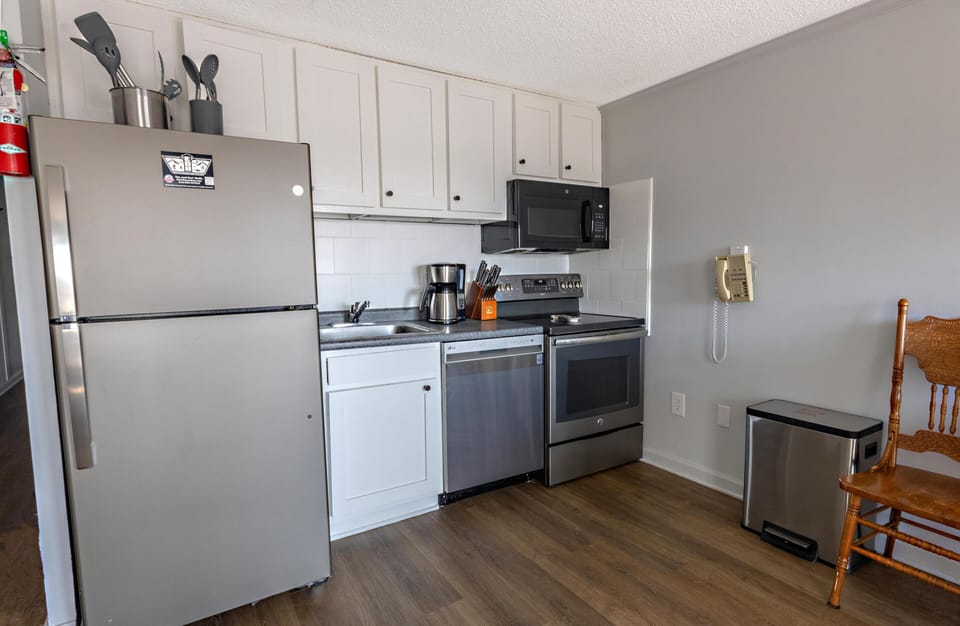 The updated kitchen, with stainless steel appliances, is fully stocked for your culinary needs.