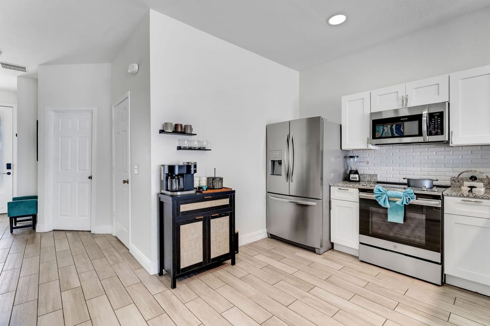 Stainless steel appliances with granite counter top.