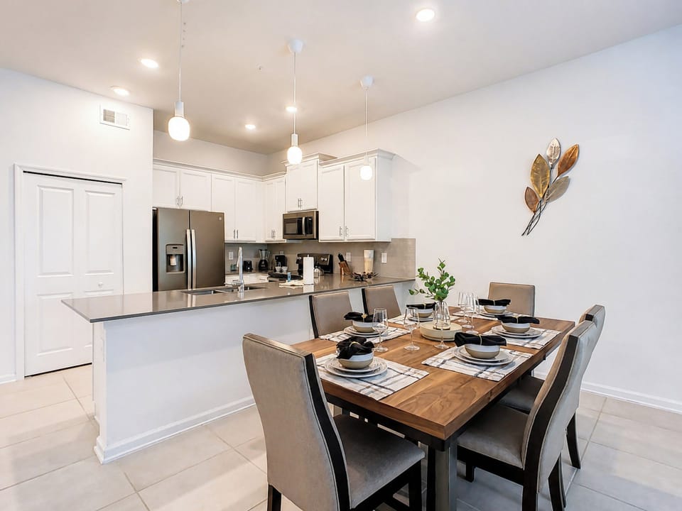 Open-concept dining area and modern kitchen with breakfast bar