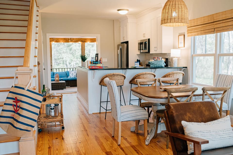 The open living space encourages conversation. From the kitchen you can chat with folks on the screened in porch or in the living room.