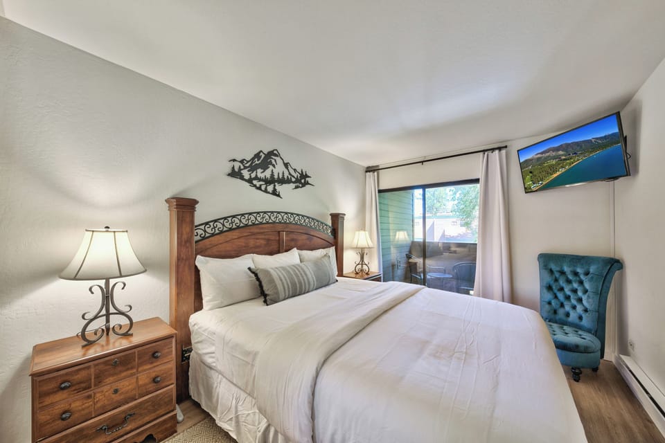Sink into crisp linens and rustic charm in your cozy bedroom, complete with mountain-themed decor and a flat-screen TV for your comfort.