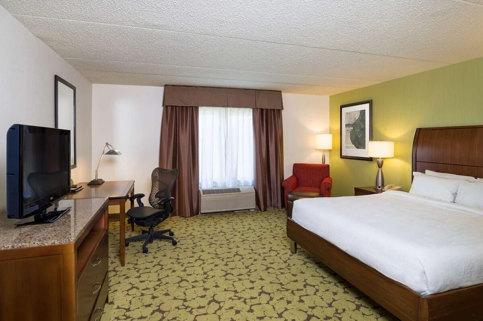 Recharge in a quiet king room with seating and workspace.