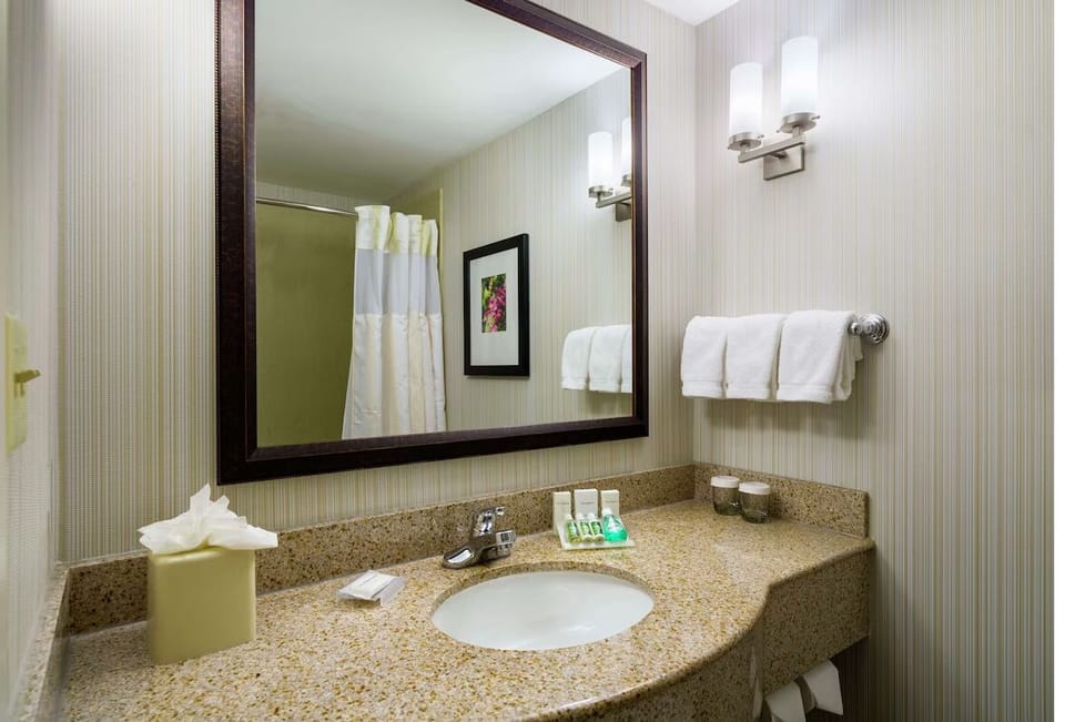 Freshen up with plush towels and a clean, bright vanity.