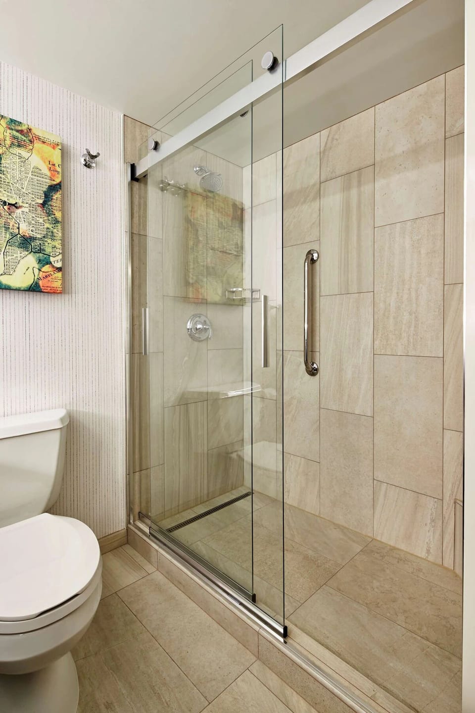 Refresh under a sleek glass shower with spa-like calm.