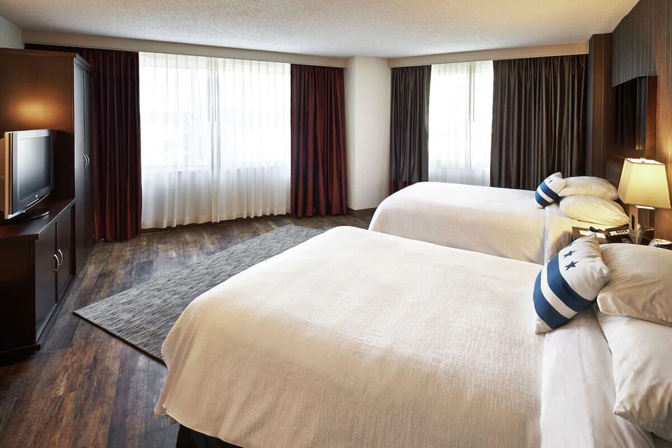 Wake up to soft daylight spilling across two plush beds.