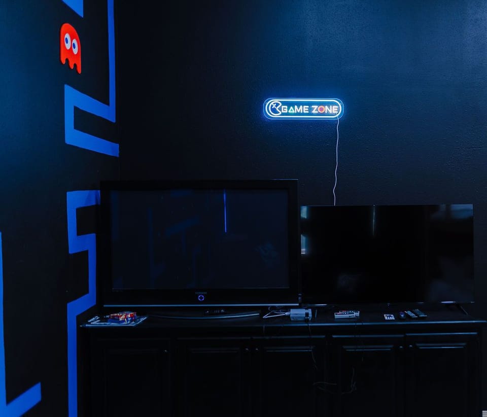 the bunk bed room is the ultimate gaming room w/ 50" inch TVs and arcade machine