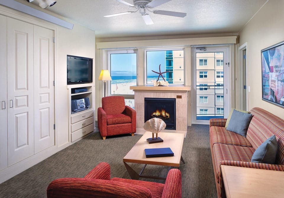 Living room with fireplace and a hidden queen size murphy bed.