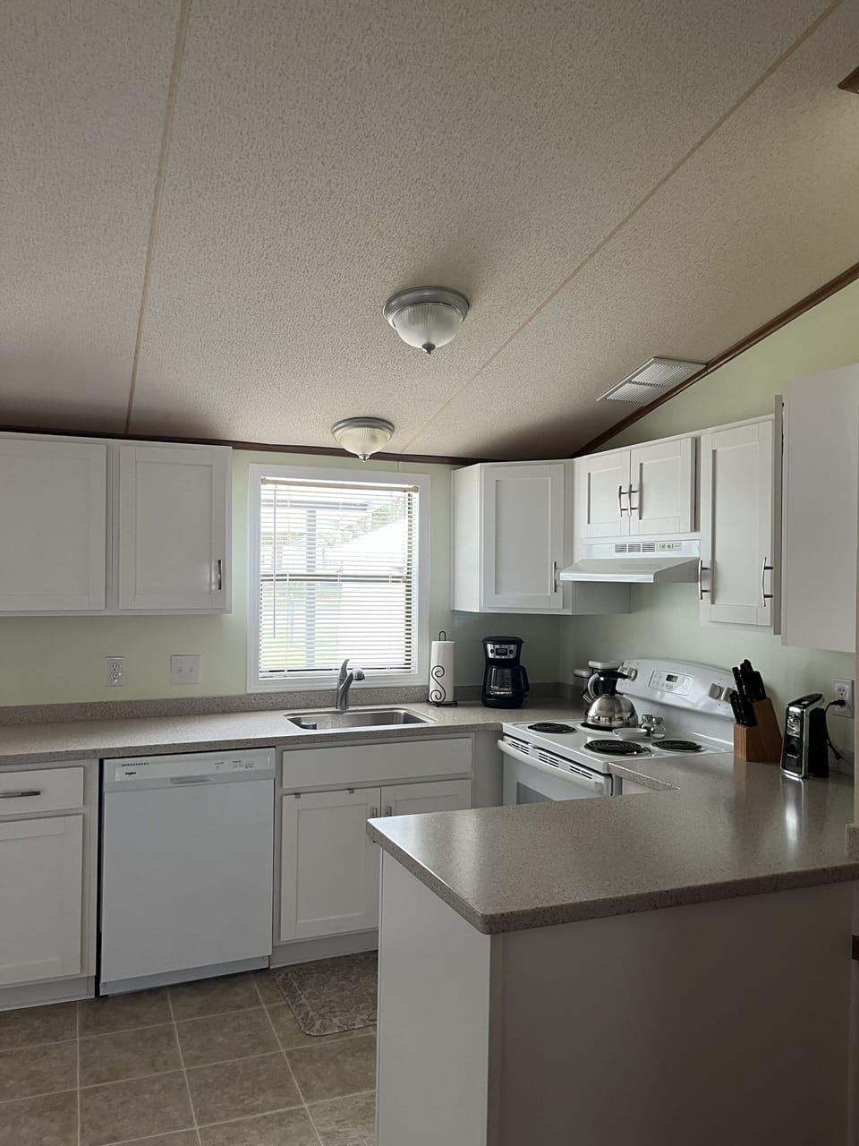 Full size kitchen with fridge, DW, utensils, basic condiments