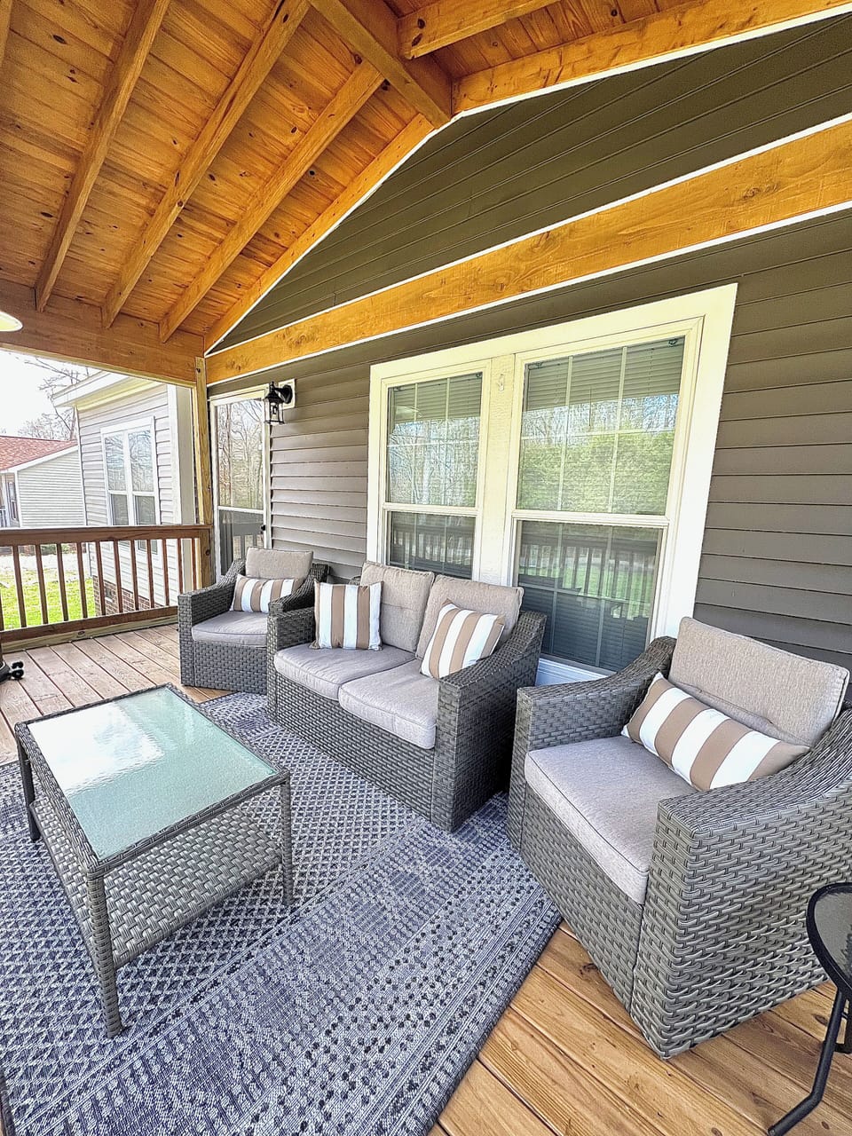 Spacious screened-in front porch with plentiful seating!