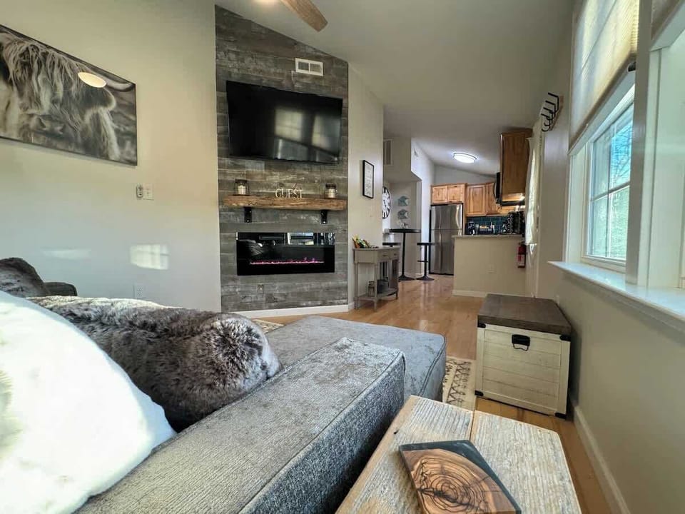 Open living room, kitchen, and entryway compose the front half of the cabin.