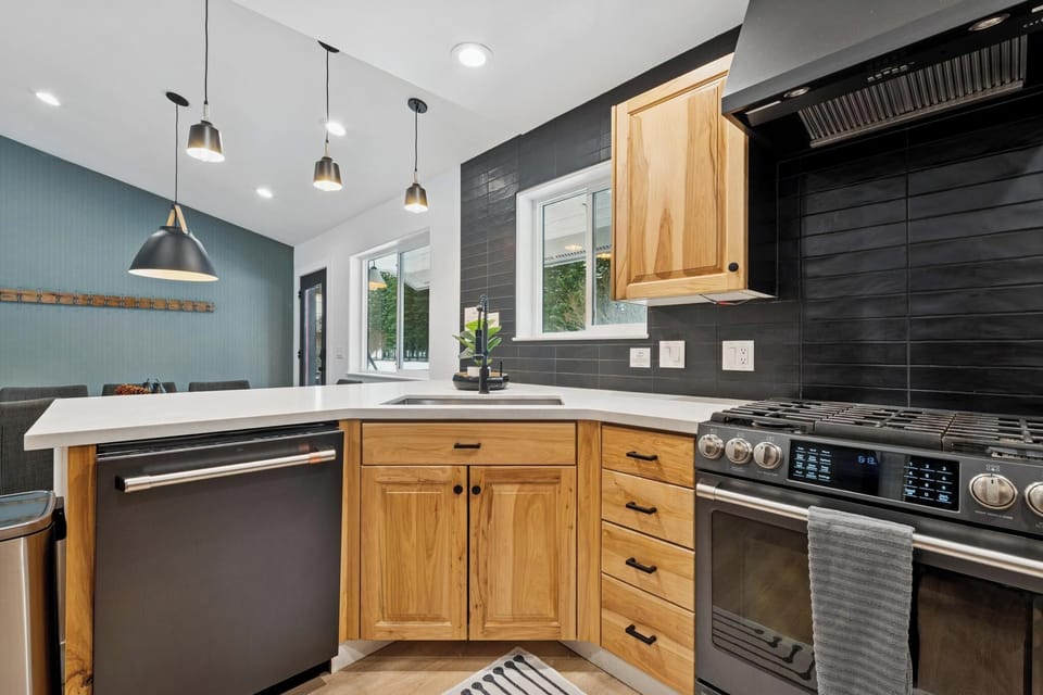 Your modern kitchen features warm wood cabinets, sleek countertops, and professional appliances—perfect for creating memorable meals together.