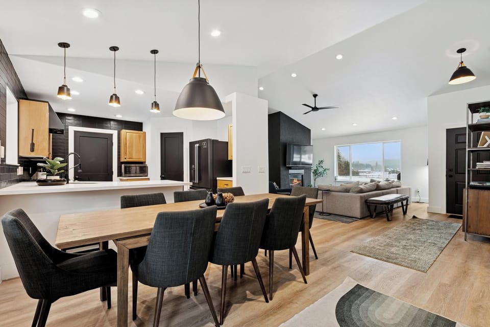 Gather around your spacious dining table while meals simmer in the modern kitchen, then unwind by the cozy fireplace in your bright living space.