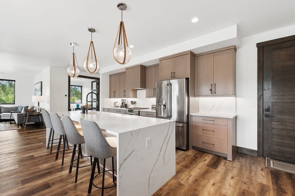 Beautiful, modern kitchen featuring a spacious island, warm wood tones, and sleek finishes—the perfect space for gathering and cooking memorable meals.