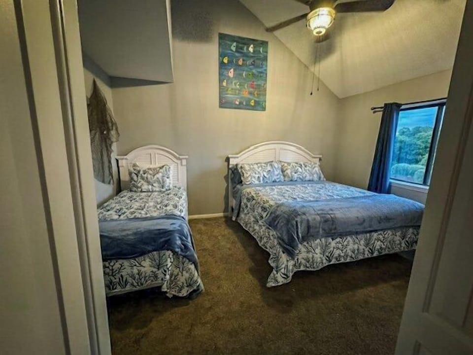 Your cozy bedroom features twin and queen beds with beautiful botanical prints, plus a mountain view window for peaceful mornings.