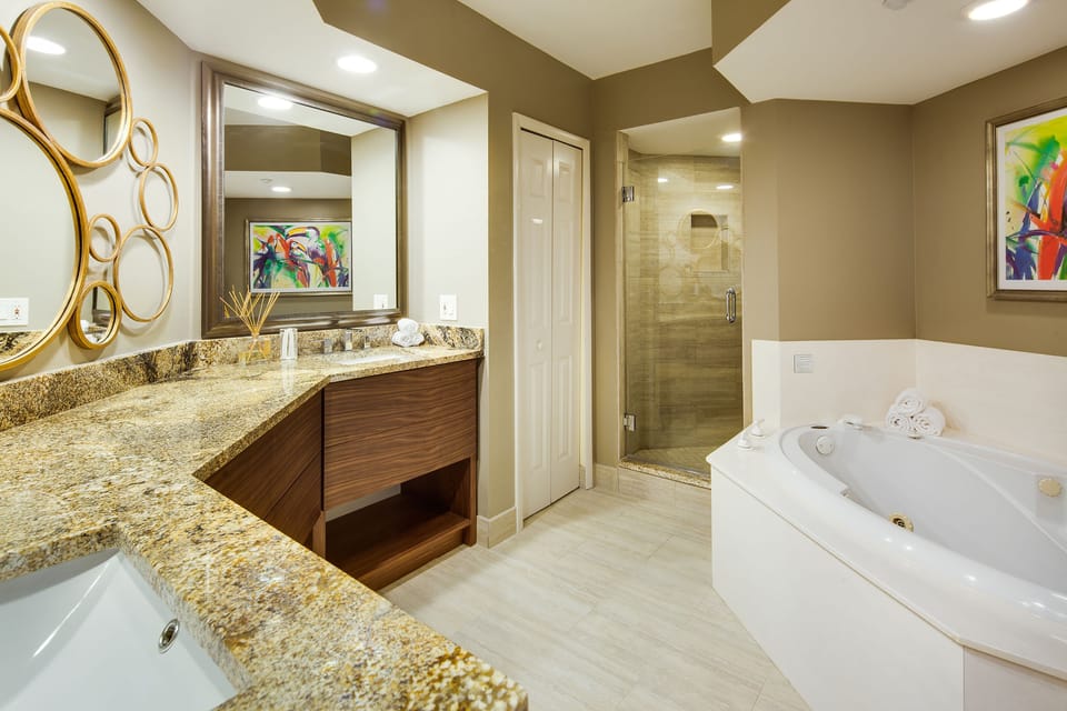 Refresh in a spa-like bath with soaking tub and glass shower.