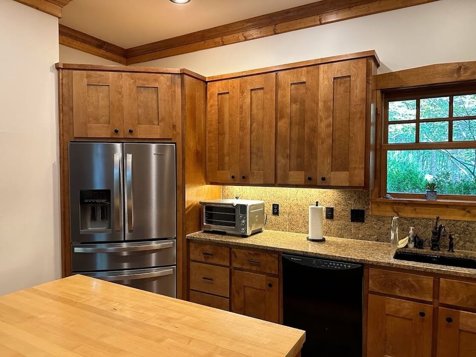 Kitchen has island with two seats.