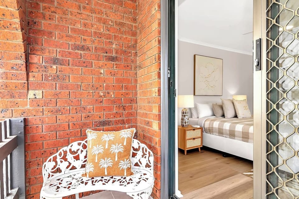 A balcony adjoining the primary bedroom provides a cosy spot to unwind with a book while you take in water views. 
