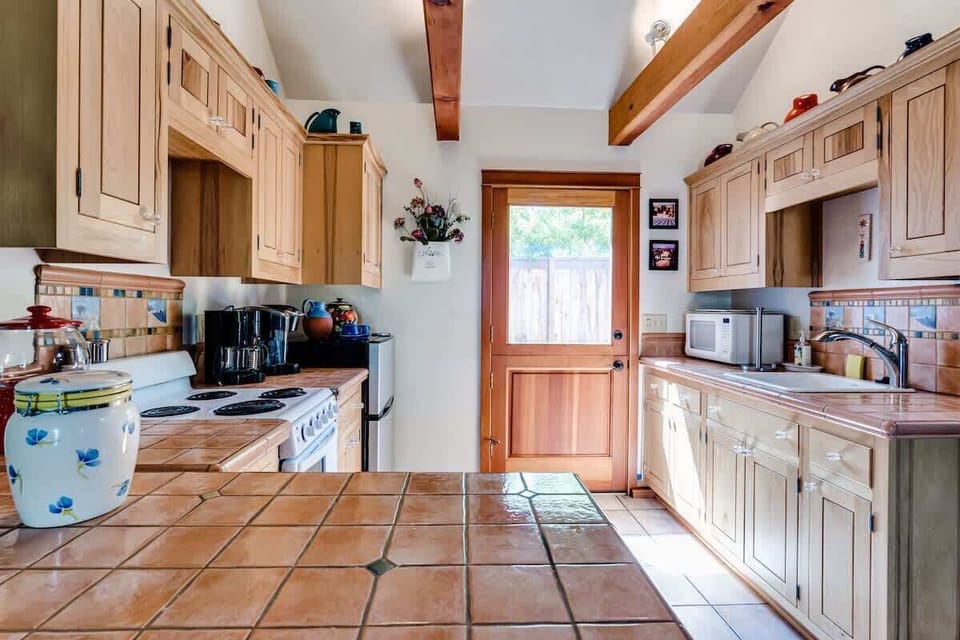 Fully equipped kitchenette with stove/oven, small fridge, microwave, coffee pot, and Keurig pod machine—perfect for preparing meals or enjoying your morning coffee before heading out to explore Eugene or Autzen game day.
