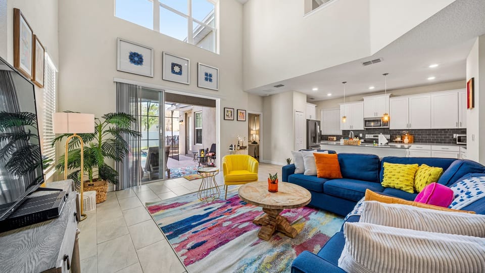 Spacious living room with multi story window; has direct access to the outdoors