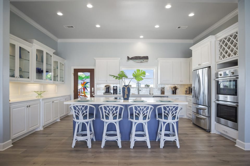 The Paradise Palms Kitchen: Embrace seaside living in this impeccably designed kitchen, highlighted by oversized windows that flood the room with natural light and offer breathtaking views of the Gulf of America