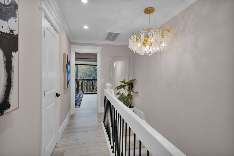 Second-floor hallway. Step upstairs to a beautifully lit hallway, where serenity meets sophistication—your peaceful retreat awaits.