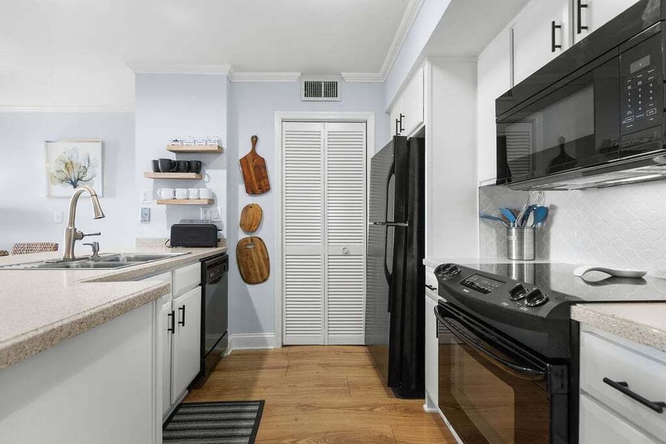 Tucked behind the kitchen pantry is the laundry's stacked washer/dryer