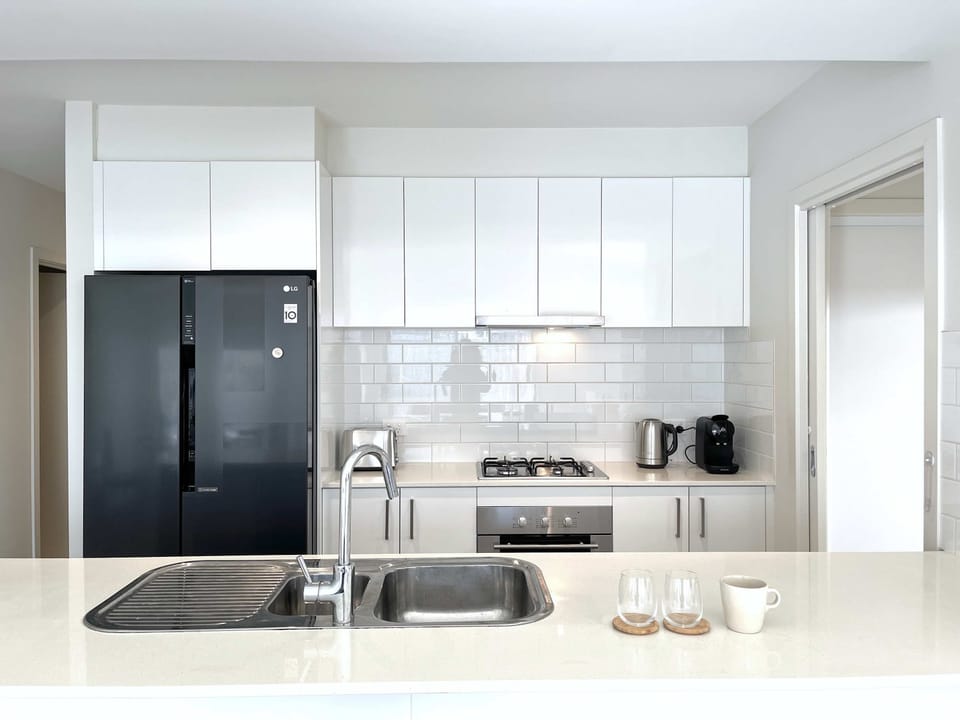Fully equipped open kitchen with capsule coffee maker
