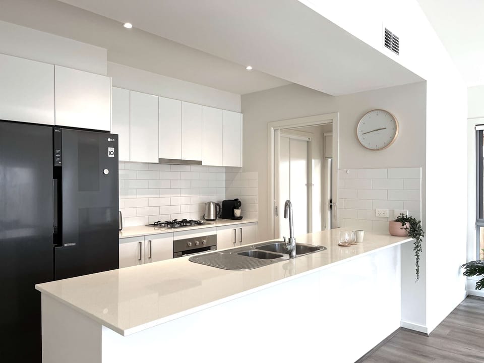 fully equipped open kitchen with large two doors fridge
