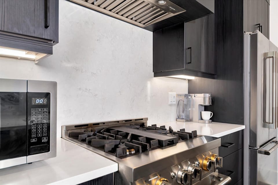 Close-up of gas cooktop & modern backsplash for easy home cooking