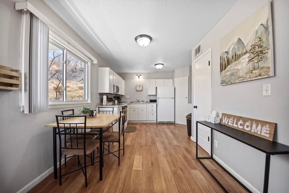 Charming dining area with expansive windows offering picturesque views of the outdoors