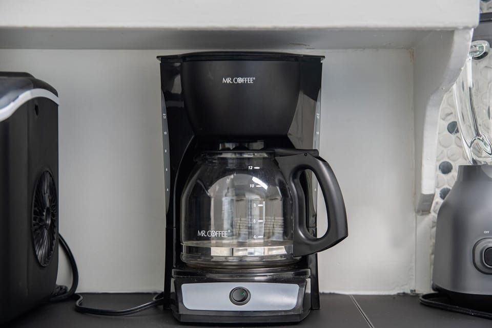 Fully stocked kitchen with all the essentials—coffee maker, cookware, blender, and more—perfect for cooking and dining together!