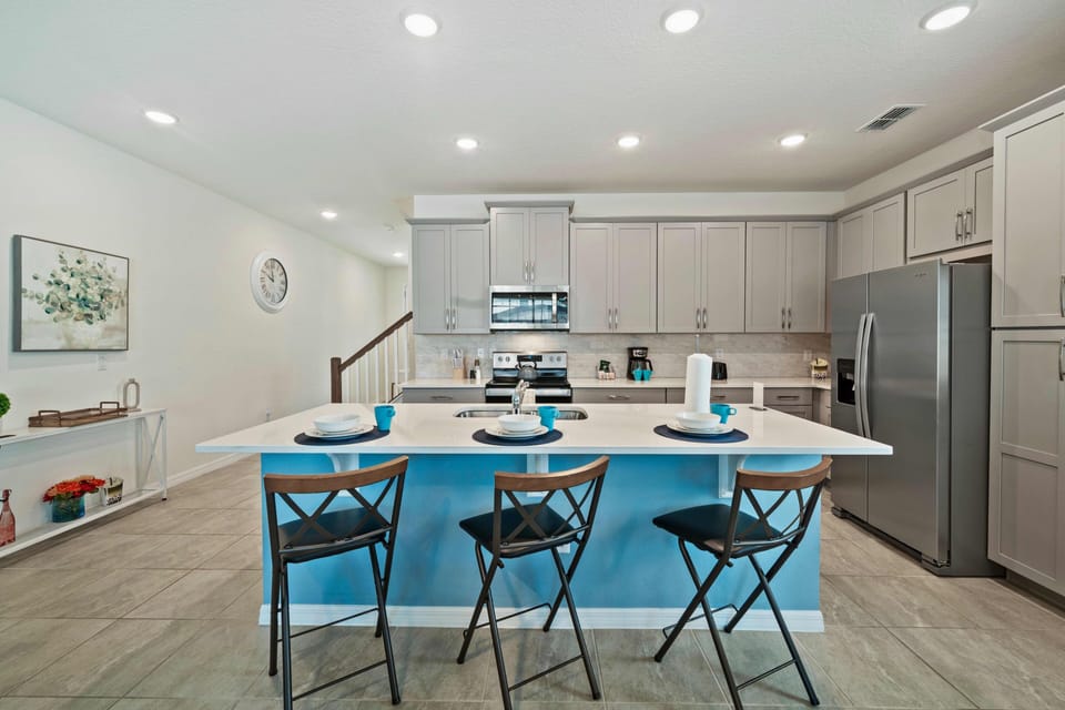 Sleek Kitchen of the Townhouse in Kissimmee Florida - Full equipped - Breakfast Bar and High Chairs - Modern kitchen with sleek, stainless steel appliances