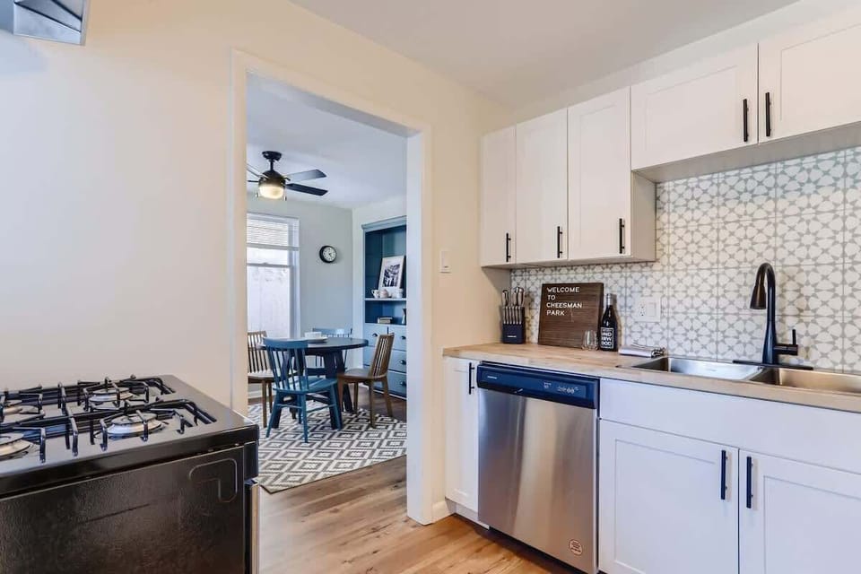 New stainless steel appliances including a dishwasher and gas stove