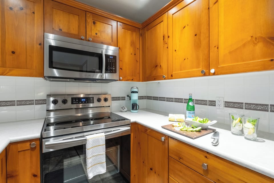 Modern kitchen with induction stove, large oven, and coffee maker.