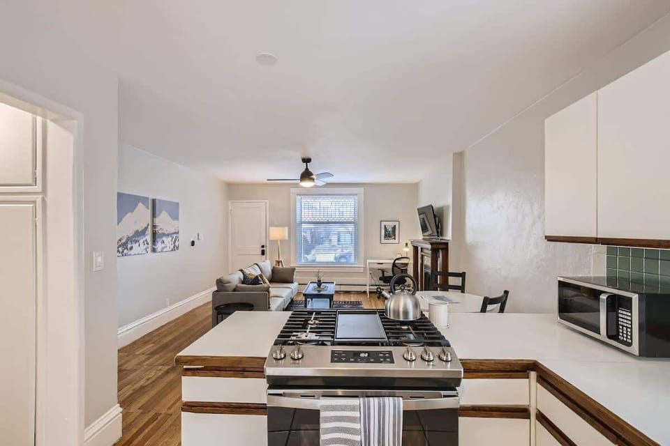 White countertops are a uniqueunit aspect of this kitchen