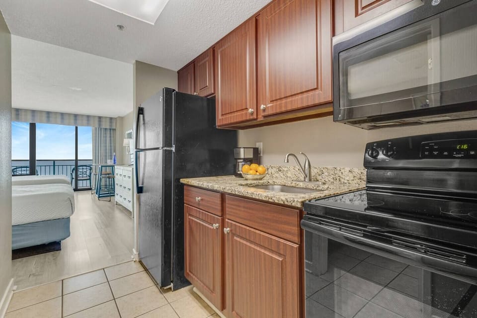 The cozy layout seamlessly connects the suite and kitchen, where modern appliances await your culinary creations.