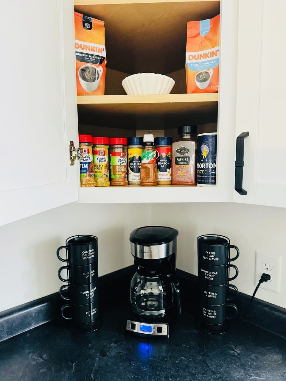 Seasonings, Coffee & filters and Sugar is in the cabinet above the Coffee maker