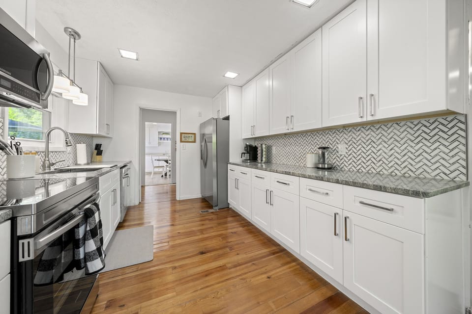 Cottage A- All brand new appliances accompanied by white cabinets and drawers.
