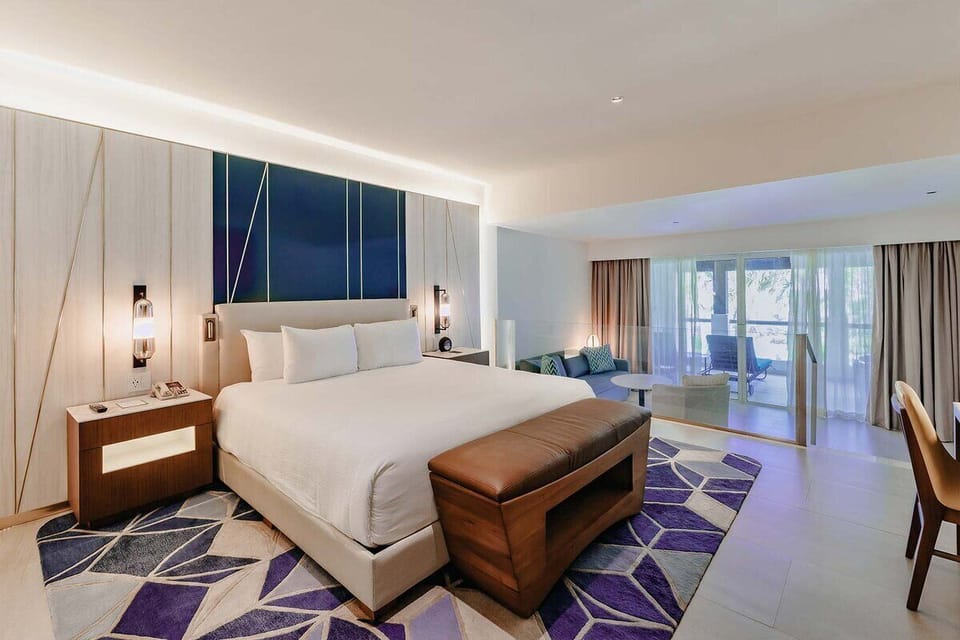 Unwind in a crisp, modern bed with soothing lighting.