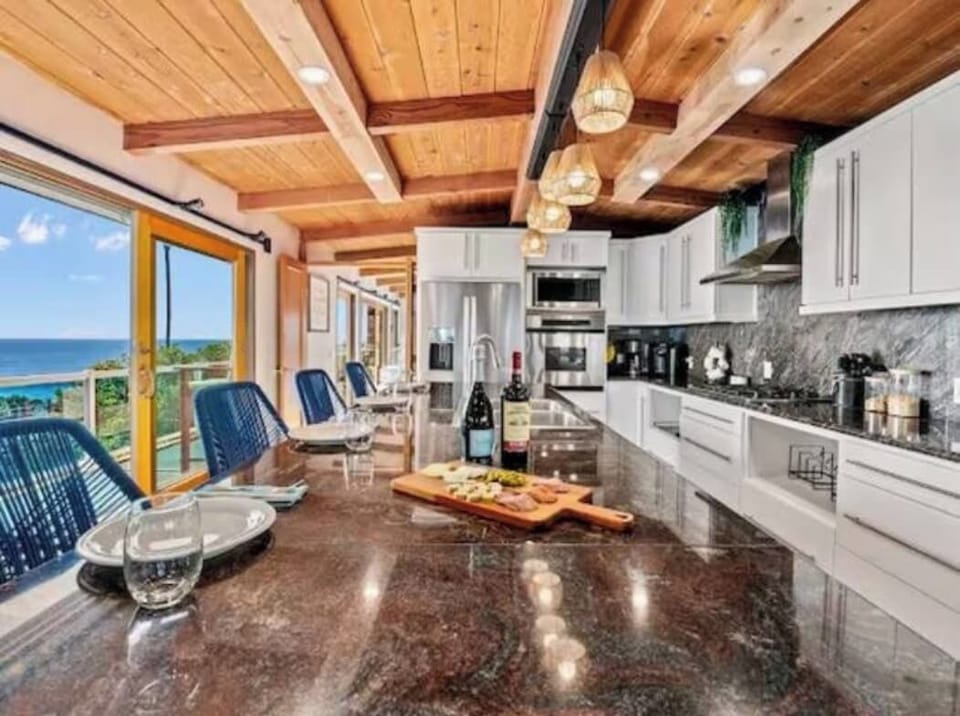 Start your day right at this inviting 4-chair island counter. In an oversized kitchen with sleek finishes and warm lighting, every breakfast feels like a moment to savor.