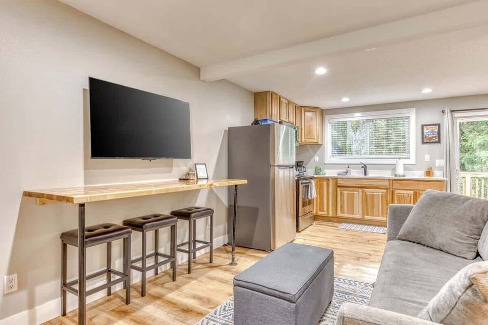 Relax and entertain in our open-concept living space! Seamless flow from comfy couch to the well-equipped kitchen.