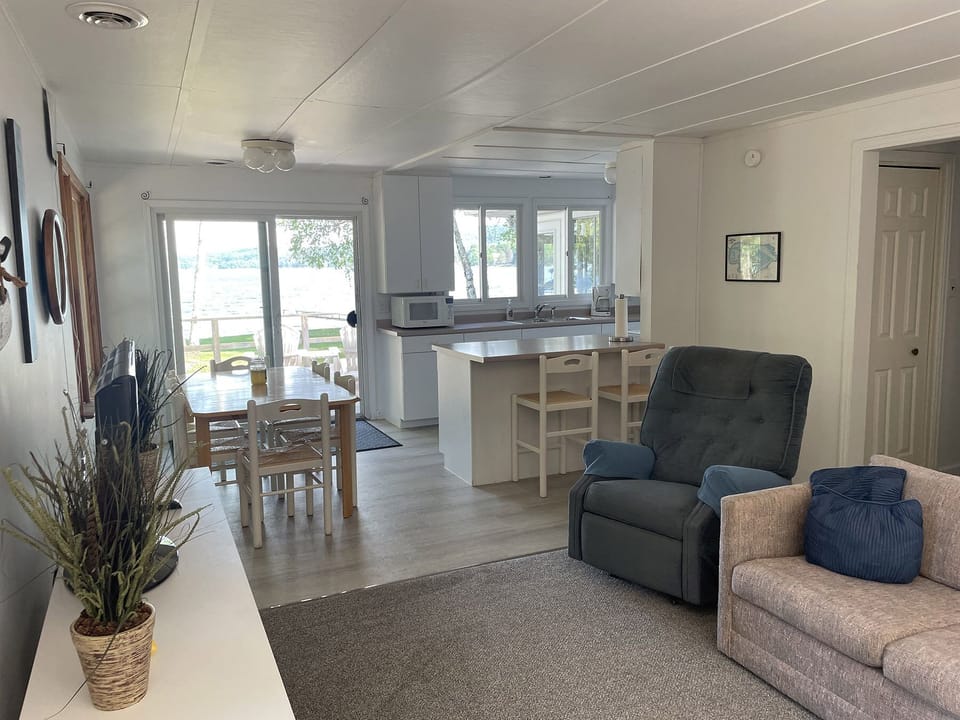 LIVING ROOM:  The cottage has a very comfy and cozy living room with a sofa, loveseat, comfy chair, and television.