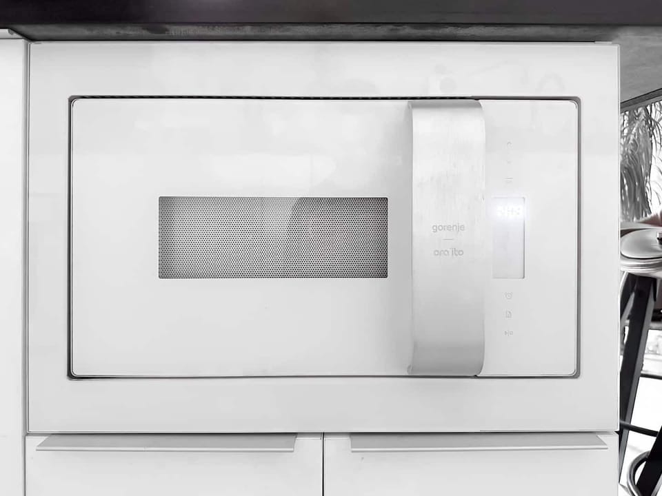 Stylish silver microwave oven set against a white backdrop, exuding modern kitchen elegance.