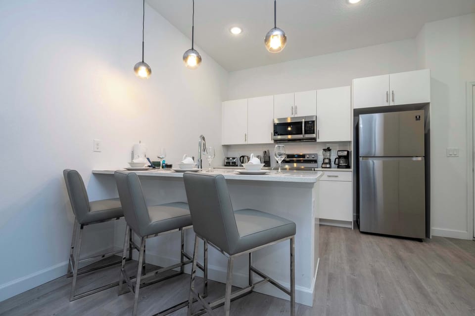 Prepare and share meals together in a modern kitchen with generous space and beautiful lighting.