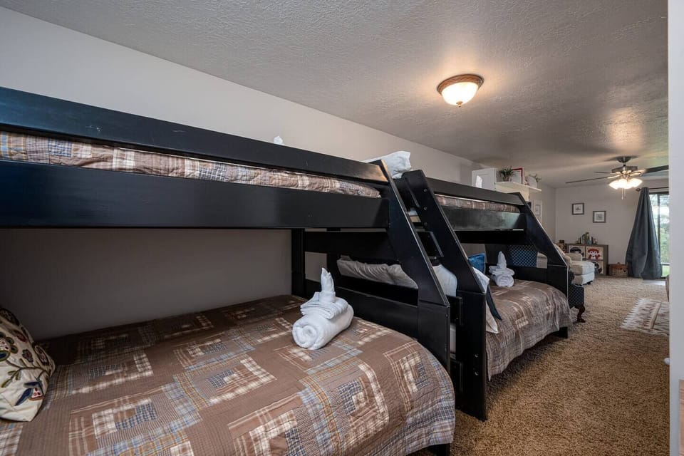 The second bedroom has two twin over double bunk beds, outfitted with luxurious linens and plush pillows. This room is on the lower level, with the family room.