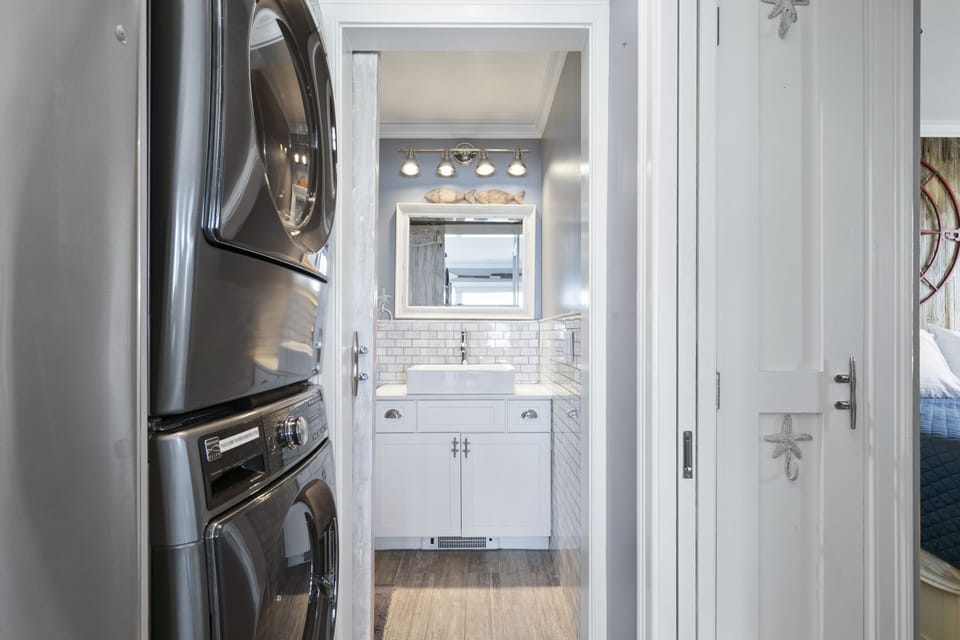 Conveniently clean and dry clothes near the bathroom with a modern washer dryer.