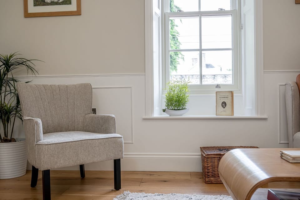 The Swaledale cosy living area detail with armchair, window seat and soft natural light.