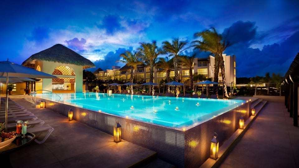 Slip into a glowing infinity-style pool at magical twilight.